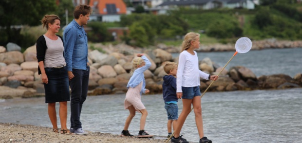 Familie går tur ved Østerstrand i Fredericia